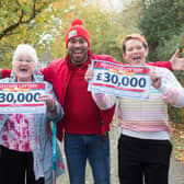 Marion McSherry-Rhoades (left) with Diane Cuthbert of Waterlooville celebrate winning a share of £120,000 in the People's Postcode Lottery. They are joined by the lottery's ambassador Danyl Johnson