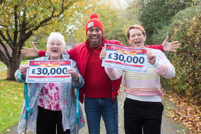 Marion McSherry-Rhoades (left) with Diane Cuthbert of Waterlooville celebrate winning a share of £120,000 in the People's Postcode Lottery. They are joined by the lottery's ambassador Danyl Johnson