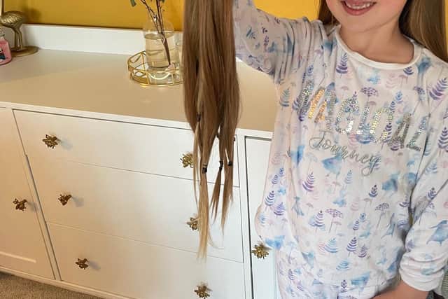 Amalie Chiverton, from Waterlooville, had 16 inches of hair cut off for the Little Princess Trust and raised more than £1,600 in the process. Pictured: Six year old Amalie holding the hair which will be donated