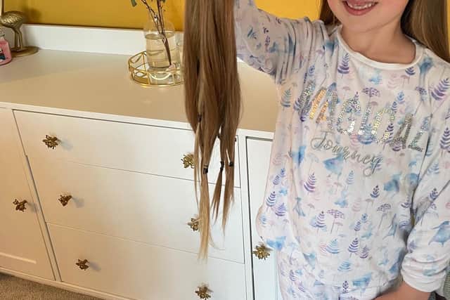 Amalie Chiverton, from Waterlooville, had 16 inches of hair cut off for the Little Princess Trust and raised more than £1,600 in the process. Pictured: Six year old Amalie holding the hair which will be donated 