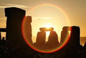 People watch the sun as it rises over Stonehenge to celebrate the Summer Solstice - one of the most popular places to watch the sunrise. However many are expected to watch it rise at Buster Hill this year (Photo by Peter Macdiarmid/Getty Images)