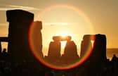 People watch the sun as it rises over Stonehenge to celebrate the Summer Solstice - one of the most popular places to watch the sunrise. However many are expected to watch it rise at Buster Hill this year (Photo by Peter Macdiarmid/Getty Images)