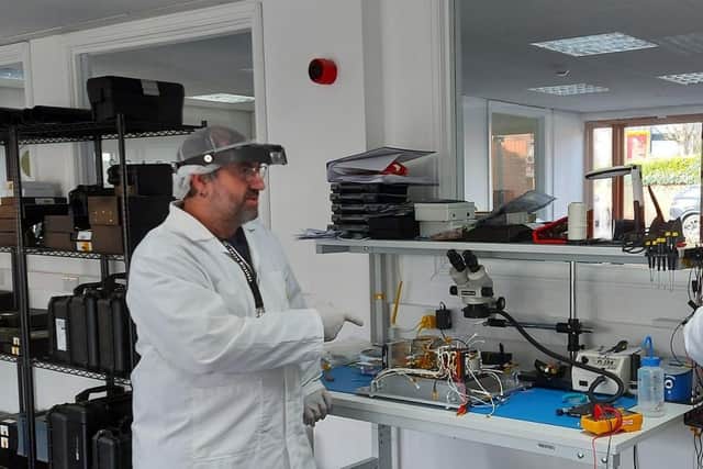 Engineers working on the satellite at In-Space