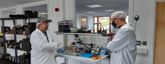 Engineers working on the satellite at In-Space