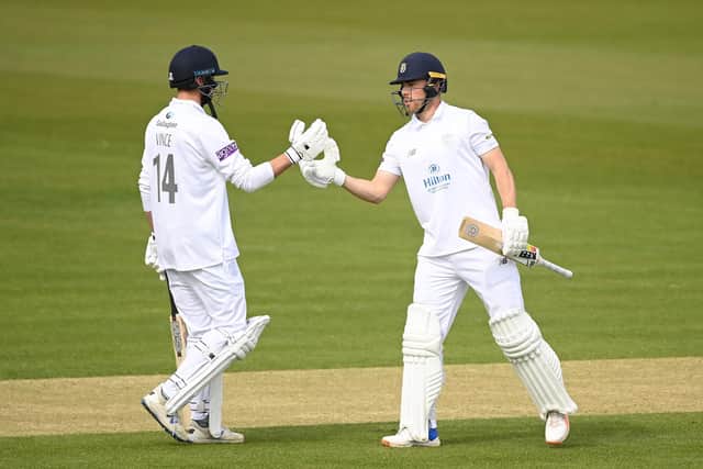 Joe Weatherley, right, celebrates with James Vince after reaching 150. Photo by Alex Davidson/Getty Images.