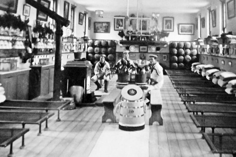 Mess deck HMS Excellent. Here we see a spotless mess deck at HMS Excellent, Whale Island. To the rear are hammocks stored in racks.