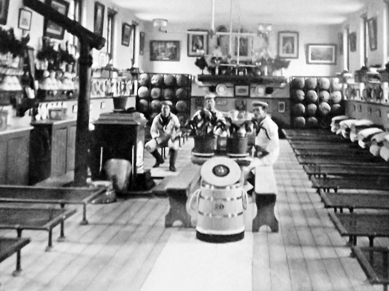 Mess deck HMS Excellent. Here we see a spotless mess deck at HMS Excellent, Whale Island. To the rear are hammocks stored in racks.