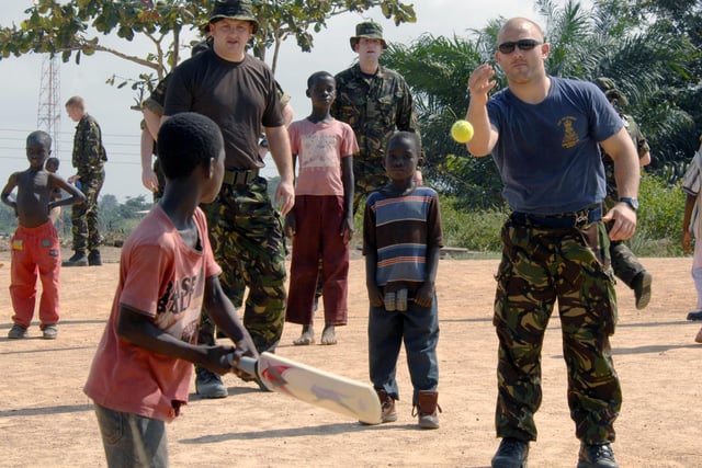 HMS Endurance brings hope to Ghana's orphans. Pictured is LPT Johnny Platt, LMet Southall and logs Andy Gallie playing cricket with some of the orphans.