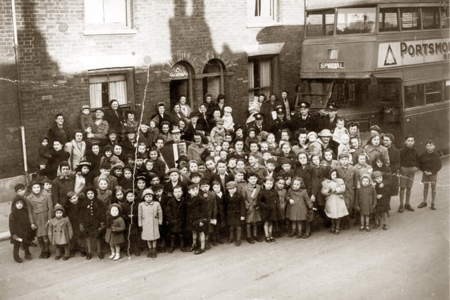 Residents gather in Buckland, Portsmouth, with 'Bunky Doo-dalee-do', real name Alfred Nicholson. The image was taken in 1945 in Sultan Road. 
He used to help run the boys’ club in Fratton Road, opposite St Mary's Church. He was well known for his Meccano skills and made a large model of either the Queen Mary ship or the Queen Elizabeth. He was always involved in raising money for some cause, he volunteered as much as physically able. He played his accordion at parties
and to the queues outside cinemas and sold the Football Mail at the top of Sultan Road.
Picture: Courtesy of Brian Duke