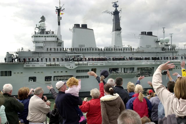 Royal Navy aircraft carrier HMS Invincible leaving Portsmouth Harbour with a large crowd of people gathered on the Round Tower at Old Portsmouth to watch the ship sail out. 6th May 2004. Picture: Michael Scaddan (042274-0041)