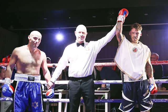 Joel McIntyre, right, has his hand raised after defeating Nikita Basin. Picture: Barry Zee