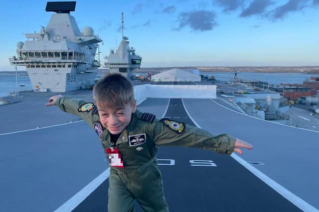 Jacob Newson, known as 'Jacob the Pilot', pictured dashing up the ski ramp of HMS Prince of Wales 'pretending to be an F-35' during his VIP tour of the warship.