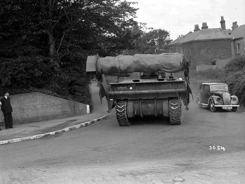 Flail tank driving past car