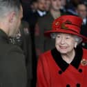 Queen Elizabeth II talks to military personnel during a visit to HMS Queen Elizabeth at HM Naval Base, Portsmouth, ahead of the ship's maiden deployment. Picture: Steve Parsons/PA Wire