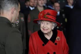 Queen Elizabeth II talks to military personnel during a visit to HMS Queen Elizabeth at HM Naval Base, Portsmouth, ahead of the ship's maiden deployment. Picture: Steve Parsons/PA Wire