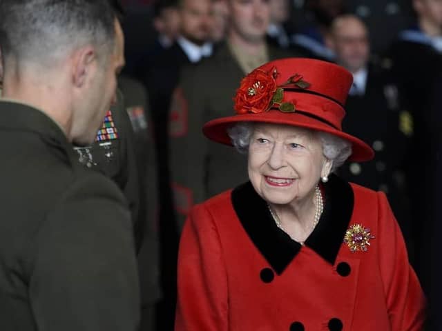 Queen Elizabeth II talks to military personnel during a visit to HMS Queen Elizabeth at HM Naval Base, Portsmouth, ahead of the ship's maiden deployment. Picture: Steve Parsons/PA Wire