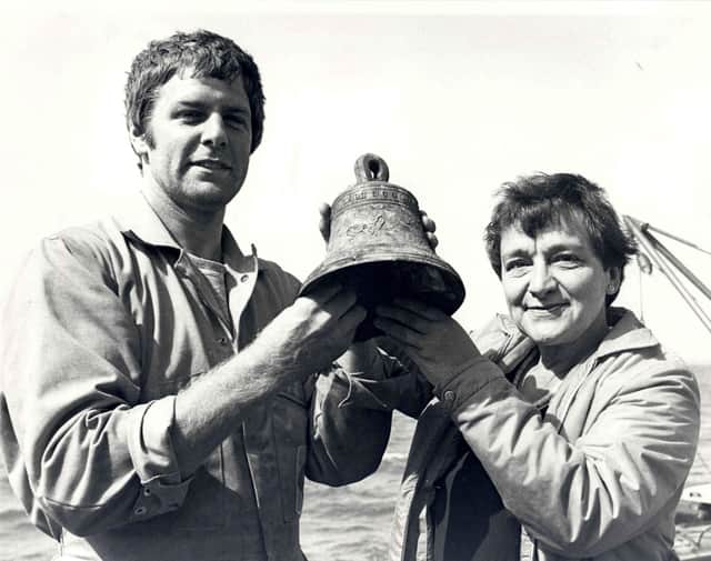 Diver Peter Ewens and Mrs Margaret Rule with the Watch bell from The Mary Rose