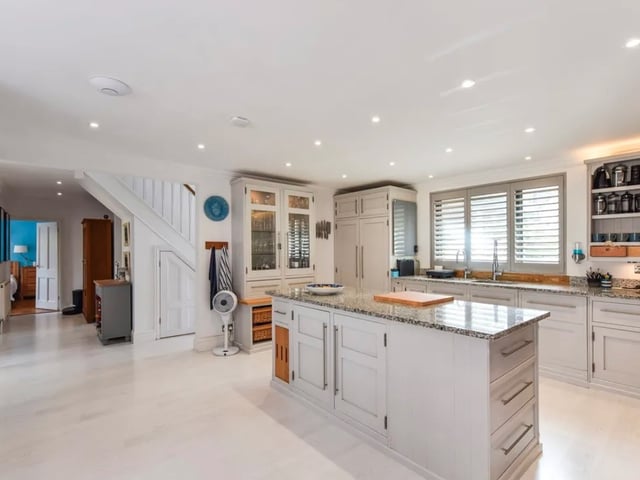 The listing says: "The ground floor consists of a sitting room featuring log burner and under floor heating, huge open plan kitchen dining area, with under floor heating and bi-folds that open up onto the gardens."