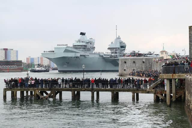 The Royal Navy aircraft carrier HMS Queen Elizabeth passes the Round Tower as it leaves Portsmouth on May 1. Picture: Andrew Matthews/PA Wire