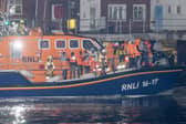 Over 100 illegal migrants aboard two RNLI lifeboats entered Portsmouth Harbour on Sunday evening just after 10pm, heading for Fort Blockhouse in Gosport, Hampshire where teams from the Home Office were there to welcome the migrants. They were then heading to board one of a number of buses waiting for them. Pictured passing Fort Blockhouse.   Please credit: pictureexclusive.com