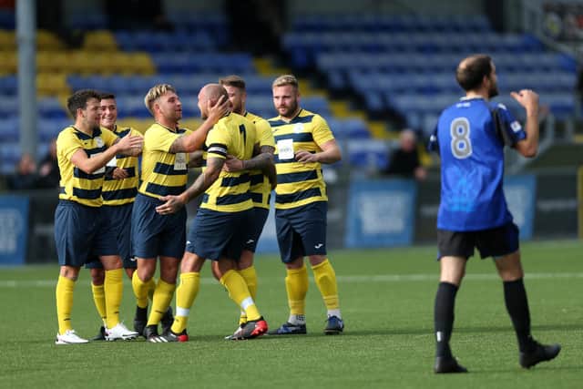Aaron Fennemore is mobbed after scoring his first goal against Clanfield. Picture: Chris Moorhouse