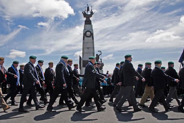 Naval Party 8901 veterans march past the 1914 Memorial.
