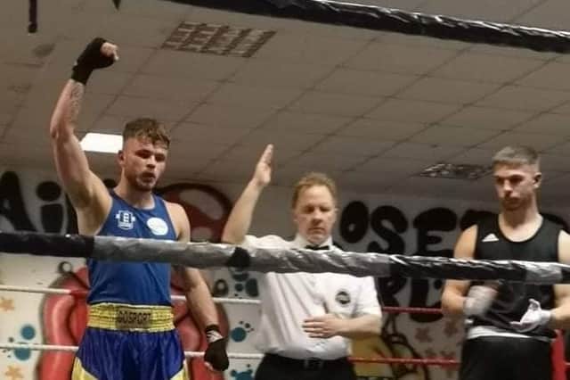 Gosport ABC's Lewis Watch, left, raises his hand after claiming a stoppage win in his first senior bout