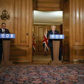 Prime Minister Boris Johnson (centre) speaks flanked by British Army Brigadier Joe Fossey (right) and Deputy Chief Medical Officer for England Jonathan Van-Tam (left) during a media briefing in Downing Street, London, on coronavirus (COVID-19). Tolga Akmen/PA Wire