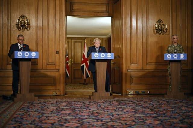 Prime Minister Boris Johnson (centre) speaks flanked by British Army Brigadier Joe Fossey (right) and Deputy Chief Medical Officer for England Jonathan Van-Tam (left) during a media briefing in Downing Street, London, on coronavirus (COVID-19). Tolga Akmen/PA Wire