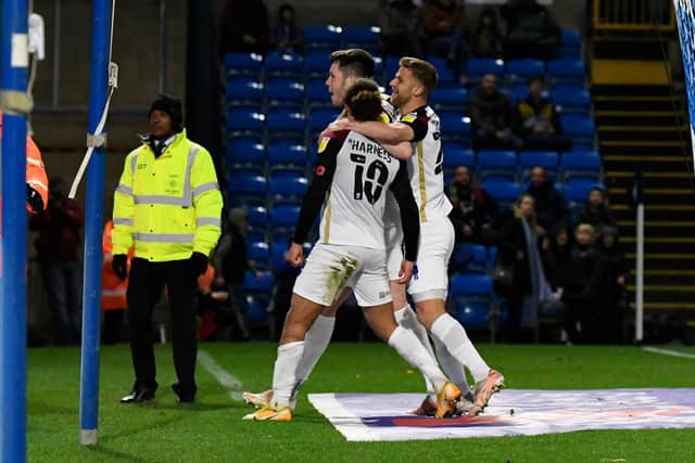 Marcus Harness celebrates his winner over Wycombe with George Hirst and Michael Jacobs. Picture: Graham Hunt/ProSportsImages