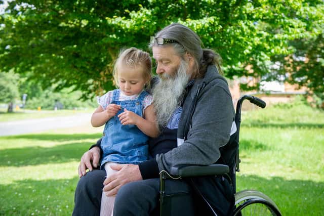 Pictured: George Allison's dad David Allison, 71 with George's daughter Ruby., three, outside their home in Leigh Park, Havant on 23 June 2021
George was murdered by his friend in May last year. Ruby is pictured looking at a necklace containing the ashes of her father.
Picture: Habibur Rahman