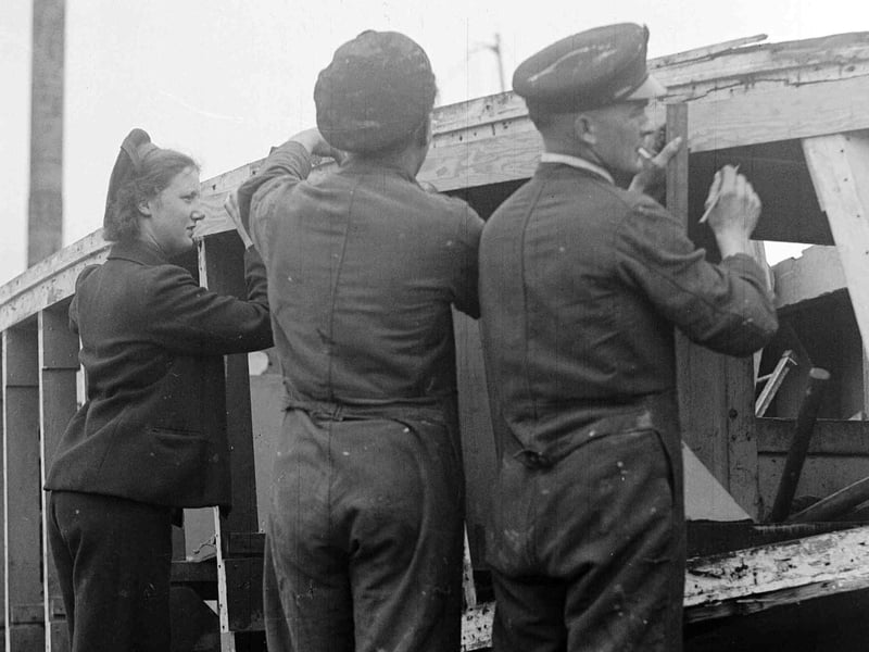 Men and women working on landing craft