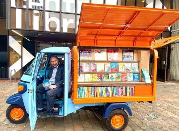 Councillor Steve Pitt, leader of the council, posing in the Tuk-tuk outside central library