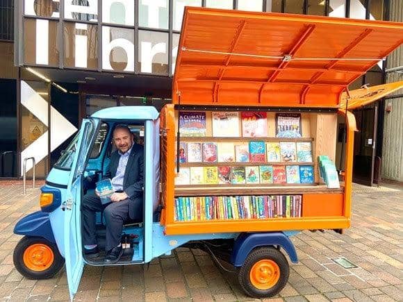 Councillor Steve Pitt, leader of the council, posing in the Tuk-tuk outside central library