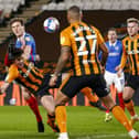 Sean Raggett makes connection with Jacob Greaves, who in turn heads the ball into his own net, giving Pompey an early lead at Hull tonight. Picture: Daniel Chesterton/phcimages.com