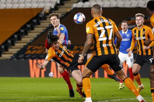 Sean Raggett makes connection with Jacob Greaves, who in turn heads the ball into his own net, giving Pompey an early lead at Hull tonight. Picture: Daniel Chesterton/phcimages.com