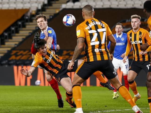 Sean Raggett makes connection with Jacob Greaves, who in turn heads the ball into his own net, giving Pompey an early lead at Hull tonight. Picture: Daniel Chesterton/phcimages.com