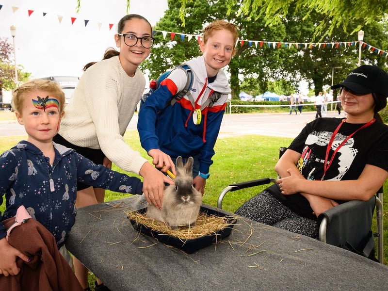 Beatrice Isherwood, Beth White Lock - Hill and Holly Isherwood pet a rabbit with Jess Murphy from the Mucky Bucket Farm