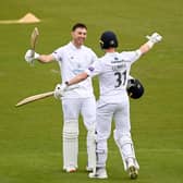 Joe Weatherley of Hampshire celebrates reaching his century with Nick Gubbins. Photo by Alex Davidson/Getty Images.