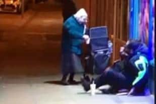 This was the moment an elderly woman was recorded handing out food to those on the street. She has since become an internet sensation. Photo: Charlie Franks