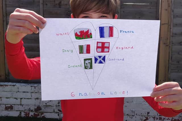 A pupil from Langstone Junior Academy holds up a message of support.