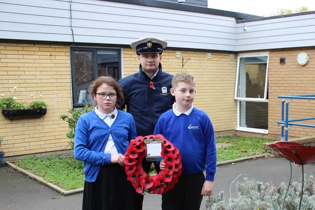 Teacher and sea Scout leader, Mr Merrified, with service children Keira Moss and Josh Winspear both aged 10.