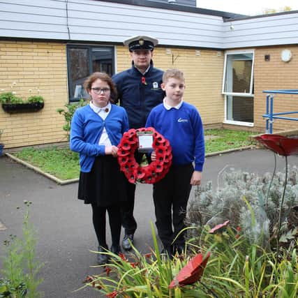 Teacher and sea Scout leader, Mr Merrified, with service children Keira Moss and Josh Winspear both aged 10.