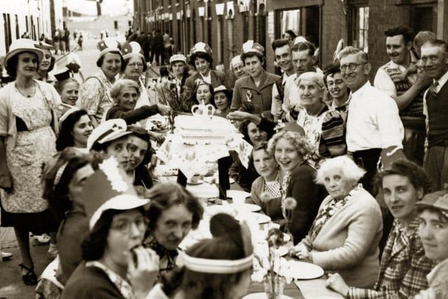 Seymour Street, Buckland 1953.

Residents of Seymour Street, Buckland tuck in to their Coronation tea. At the far end Barrington House is under construction.