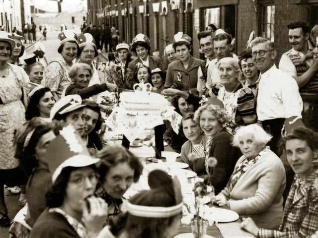 Seymour Street, Buckland 1953.
Residents of Seymour Street, Buckland tuck in to their Coronation tea. At the far end Barrington House is under construction.
