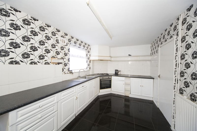 The kitchen boasts integrated oven and gas hob.