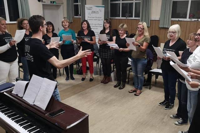 Encore Choirs, based in Petersfield and Farnham, are run by Portsmouth resident Josh Robinson and his fiancee Gemma Ford. Pictured: A choir group performing together before they had to meet online