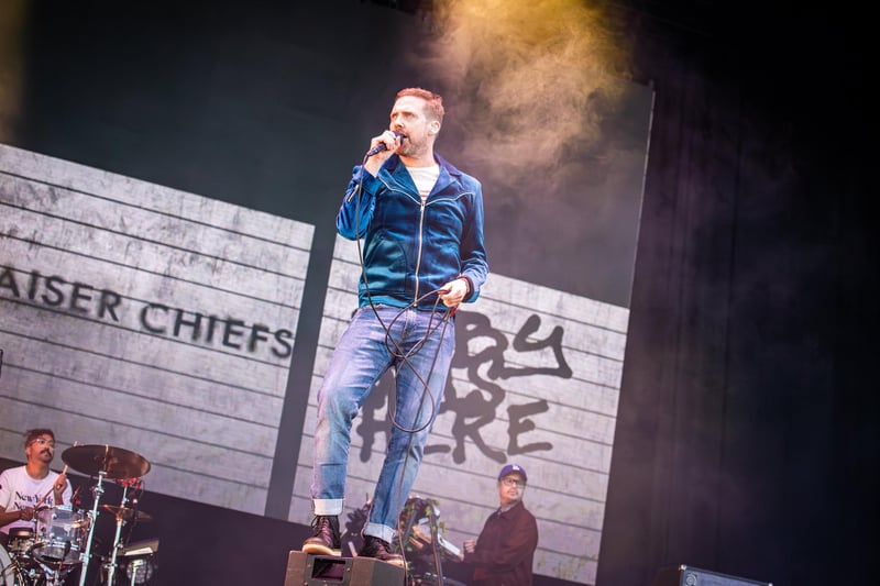 Ricky Wilson standing on a speaker during the band's performance. Photos by Alex Shute