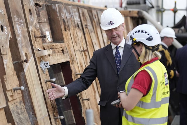 Vice Admiral Sir Tim Laurence speaks to a shipwright during a visit to see the HMS Victory Conservation Project at the National Museum of the Royal Navy in Portsmouth Historic Dockyard.