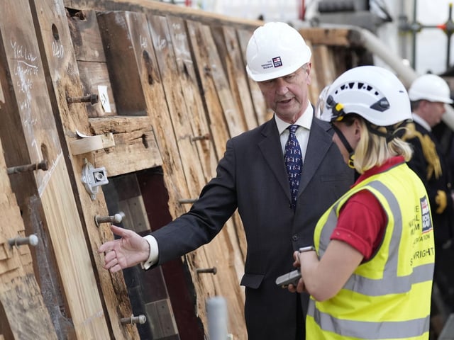 Vice Admiral Sir Tim Laurence speaks to a shipwright during a visit to see the HMS Victory Conservation Project at the National Museum of the Royal Navy in Portsmouth Historic Dockyard.